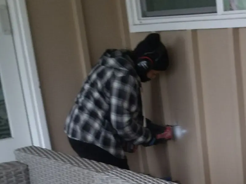 Professional electrician installing an exterior outlet in Veteran