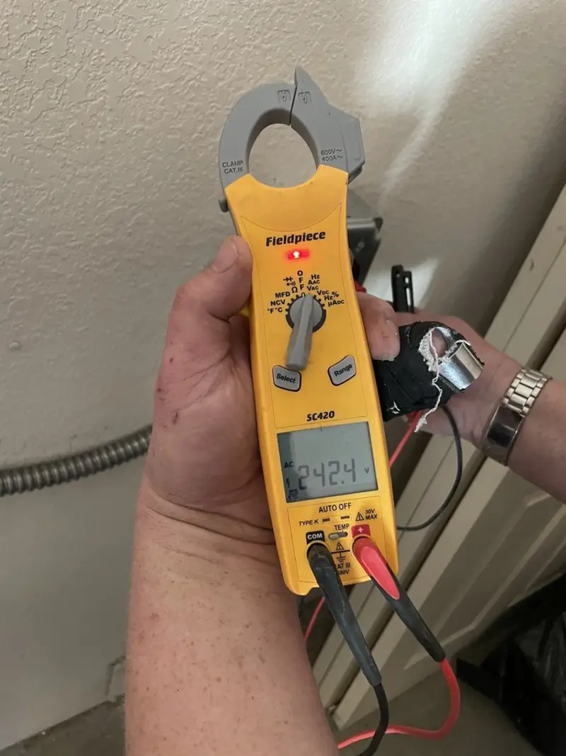 Voltage testing with clamp meter during Ceiling Fan Installation in Veteran
